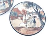 two plates with a painting on them on the wall