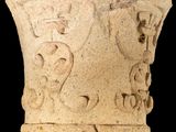 an image of a stone vase with a design on it