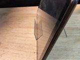 a laptop computer sitting on a wooden table with a black background