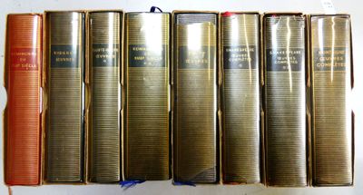 plusieurs vieux livres sont alignés sur une étagère, les uns à côté des autres