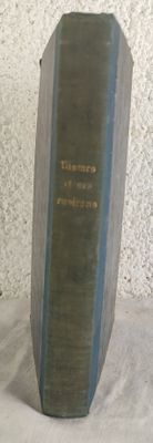 a book that is sitting on a table next to a vase