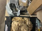 a pile of boxes and a bag of stuff on the floor
