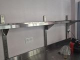 a kitchen with a stainless steel counter top and a refrigerator