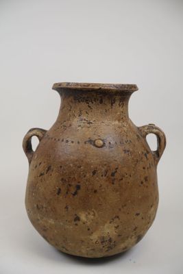 un vase marron muni d'anses, sur un fond blanc