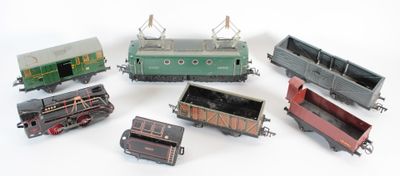 several toy trains are lined up in a row on a white surface