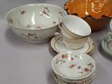 many plates and bowls that are sitting on a table