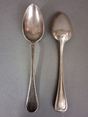 two spoons sitting next to each other on a table