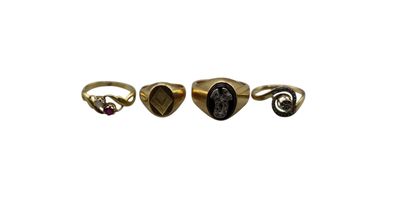 three gold rings with black stones on them on a white background