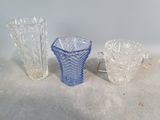 three glass vases sitting next to each other on a table