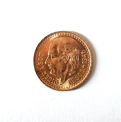 a coin with a picture of a man on it on a white surface