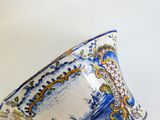 a blue and white bowl with a design on it