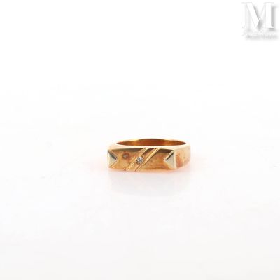 a close up of a gold ring on a white surface