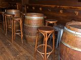 a wooden bar with a lot of stools and tables