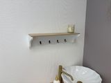a bathroom with a white sink and a gold faucet on the wall
