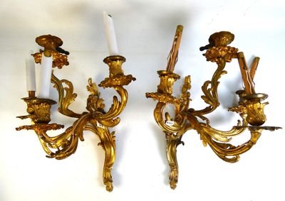 two candles that are on the wall next to each other
