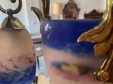 a person holding a vase with a picture on it