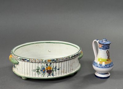 two vases and a bowl sitting next to each other on a table