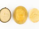 three different types of soap sitting on top of a white surface