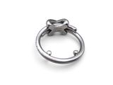 a silver ring with a star on it on a white surface