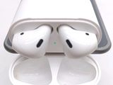 two airpods that are sitting on top of a case