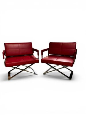 pair of red leather lounge chairs with chrome legs and arms