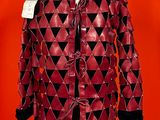 a red leather coat with black and white triangles on it