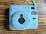 a small camera sitting on a table with a tag on it