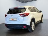 the rear of a white mazda cx - 5 parked in a garage