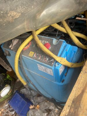 an image of a blue and yellow battery in the back of a truck