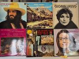 a lot of records on a table with a man in a yellow hat