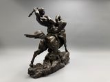 bronze statue of a man on a horse with a spear in his hand