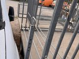 a white car parked in a parking lot next to a fence