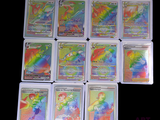 a lot of different pokemon cards on the table