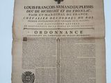 un vieux document sur lequel figure l'image d'un homme tenant une épée