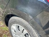 a close up of a car ' s tire on the side of the road