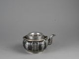 an antique silver teapot with a lid and a handle