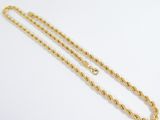 a close up of a gold chain on a white background