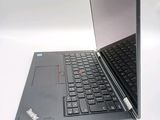 a laptop with a black keyboard on a white surface
