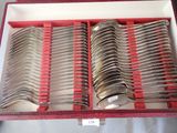 many spoons and forks in a red box