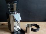 a coffee grinder sitting on top of a wooden table