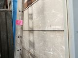 several ladders are leaning against the wall of a building