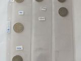 five different coins in a plastic bag on a table