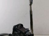 an image of a black vacuum cleaner on a white surface