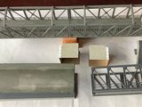 a model of a bridge and some other items on a table