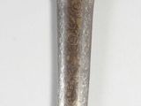 a knife that is sitting on a white surface