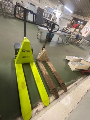 un chariot élévateur posé au sol dans un entrepôt