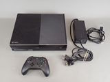 a video game console and a game controller on a table