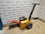 an image of a small machine that is parked in front of a wall