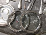 a silver tray with silverware and silver spoons on it