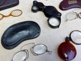 several pairs of glasses, a pair of eyeglasses, a pair of eyeglasses, a pair of eyeglasses, and a pair of eyeglass